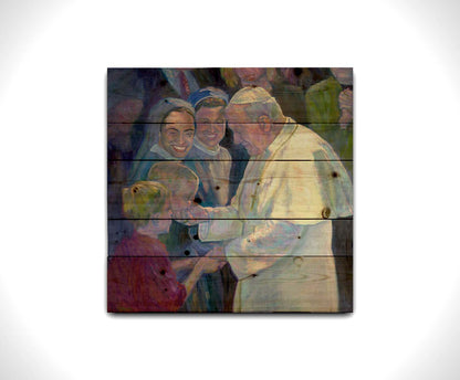 A painting of Pope John Paul II shaking the hands of children in a crowd. Printed on a wood pallet.