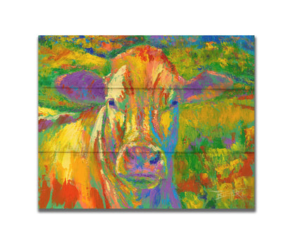 A painting of a cow standing in a pasture. It is painted in arbitrary colors, using a broad spectrum of bright colors from red through purple. Printed on a box board.