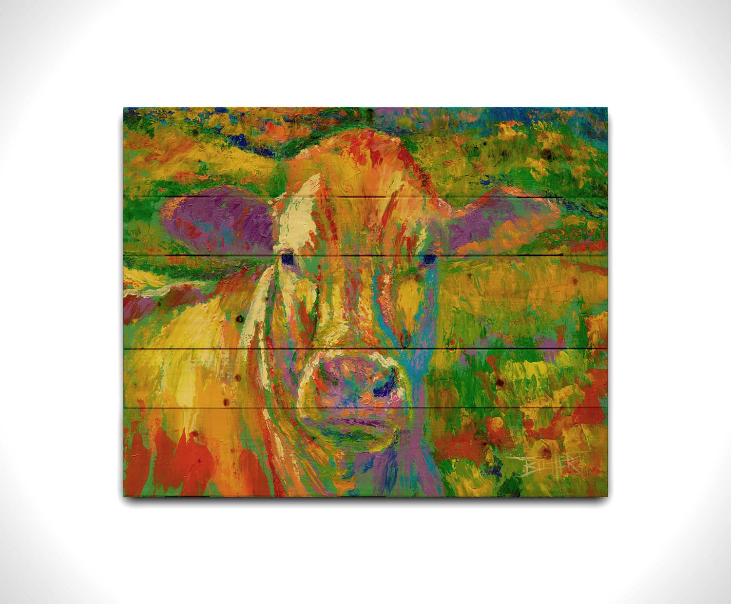 A painting of a cow standing in a pasture. It is painted in arbitrary colors, using a broad spectrum of bright colors from red through purple. Printed on a wood pallet.