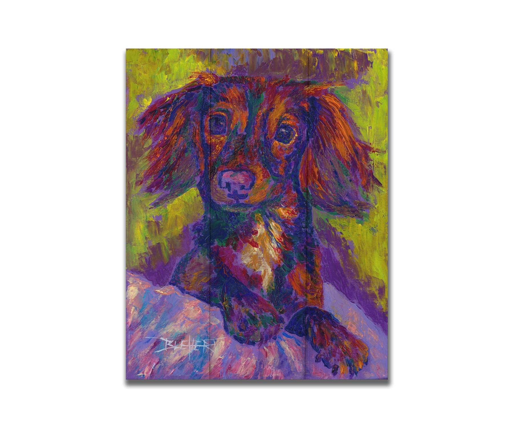 A painting of a dachshund, or wiener dog, lying on a cushion or blanket. It is perking up playfully, and it is painted using a purple, green, and brown palette. Printed on a box board.