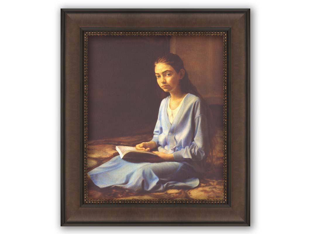 A portrait painting of a young girl dressed in blue and sitting on the floor, reading a book. It is painted in a softly lit, realistic, classical style reminiscent of the Renaissance. Printed on canvas and framed.