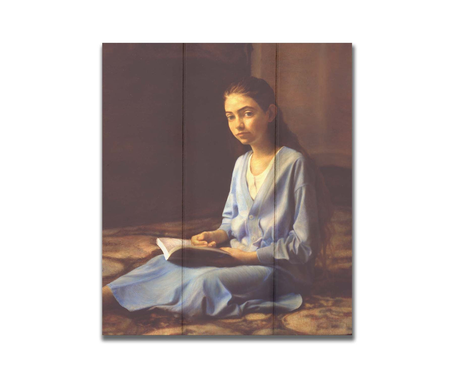 A portrait painting of a young girl dressed in blue and sitting on the floor, reading a book. It is painted in a softly lit, realistic, classical style reminiscent of the Renaissance. Printed on a box board.