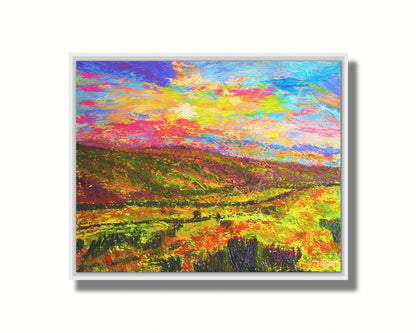 A textured, colorful impressionistic painting of a hilly meadow of flowers and an equally colorful sky. Printed on canvas in a float frame.