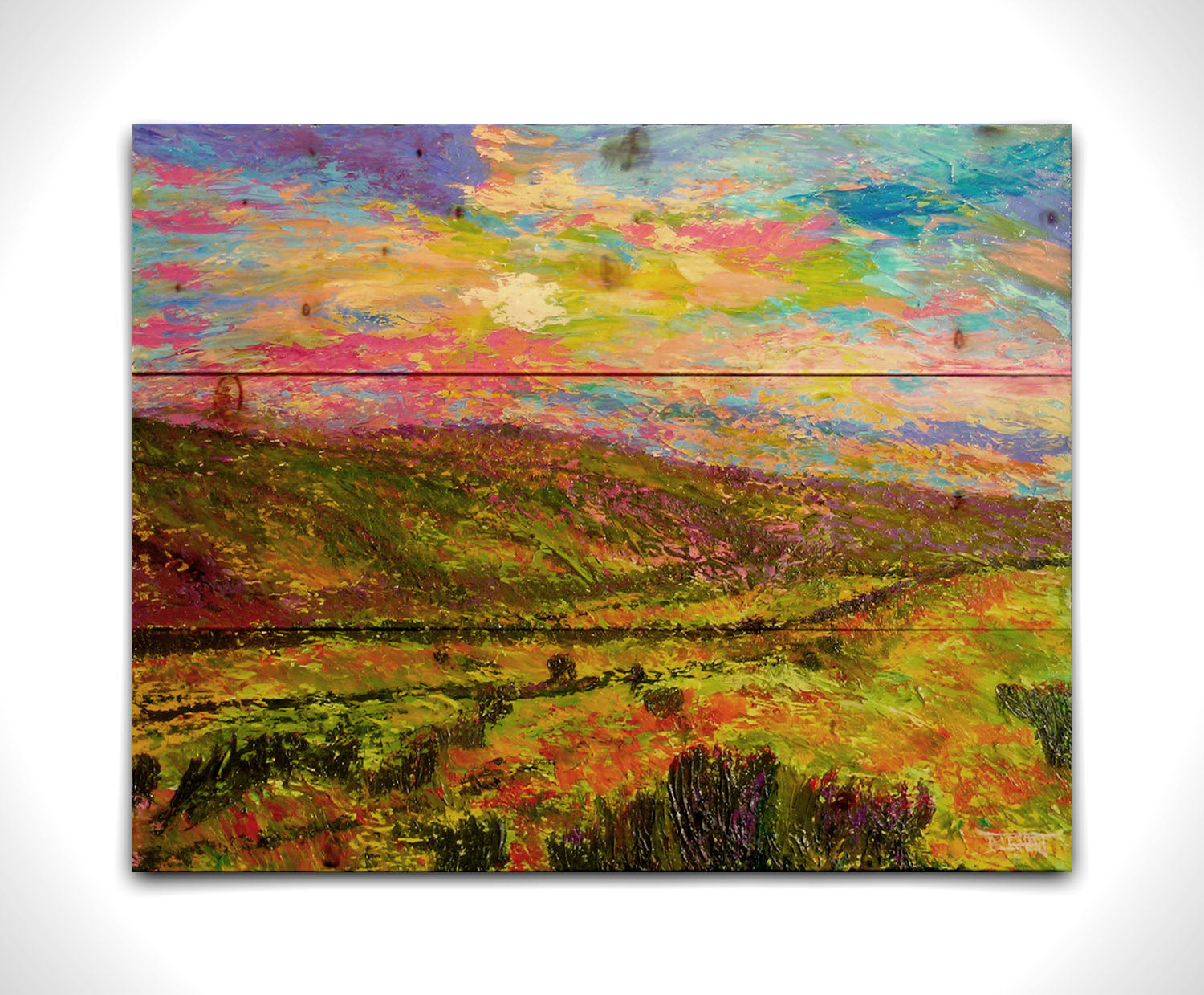 A textured, colorful impressionistic painting of a hilly meadow of flowers and an equally colorful sky. Printed on a wood pallet.