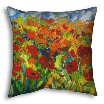 A throw pillow designed with a painting of a field of red and orange flowers, stylized in expressive large brushstrokes.