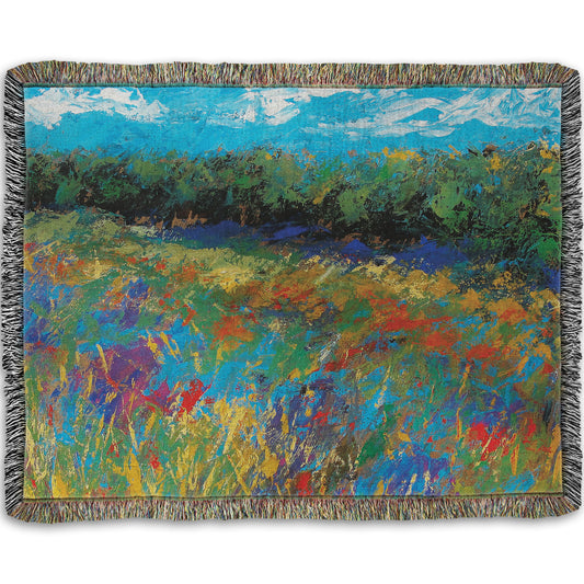 A woven throw blanket designed with an expressive painting of a field of flowers, created in bold strokes of color.