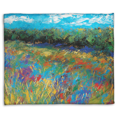 A coral fleece blanket designed with an expressive painting of a field of flowers, created in bold strokes of color.