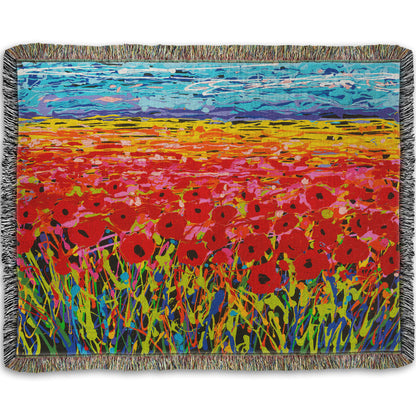 A woven throw designed with a drip painting of a field of red flowers, created with a rainbow of vibrant colors.