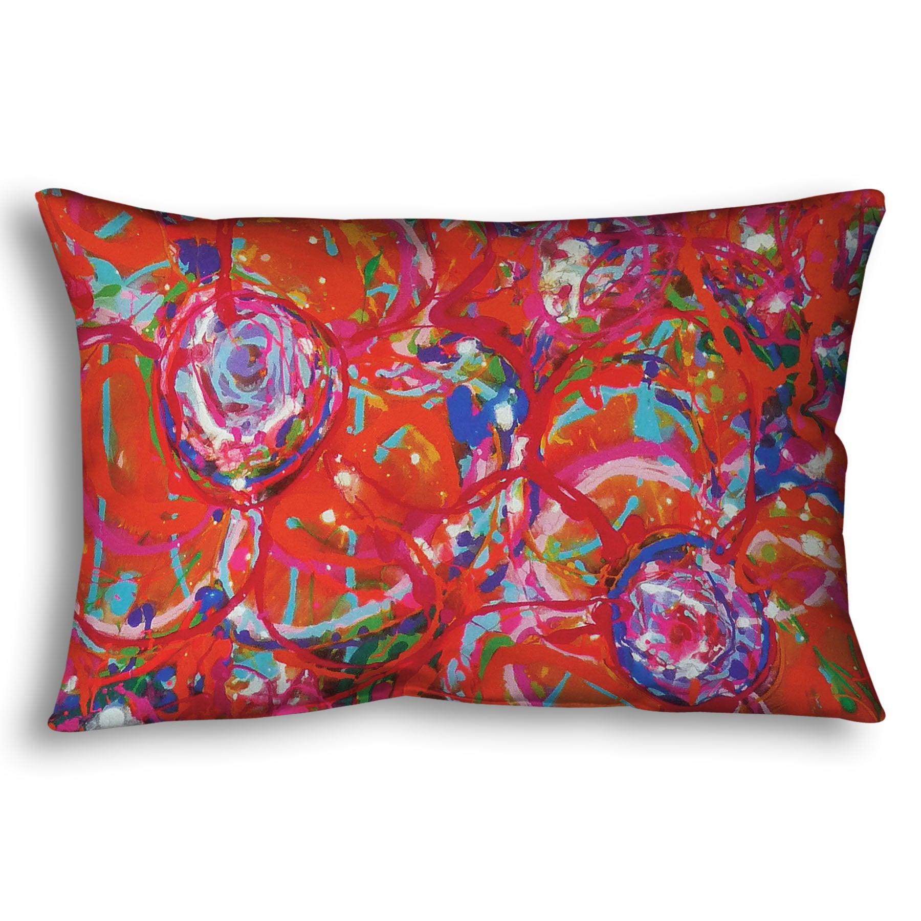 A throw pillow designed with a drip painting of a cluster of abstracted flowers created with splatters of orange, red, and pink with accents of green, blue, yellow, and purple.