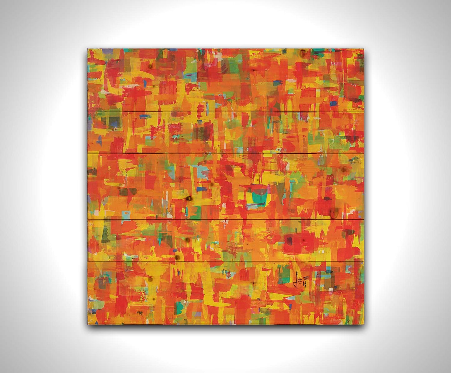 A painting of an abstract organic pattern of orange, yellow, and red accented by blue, pink, green, black, and white. Printed on a wood pallet.