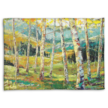 A fleece blanket designed with an expressive painting of a birch forest with the yellow leaves of fall.