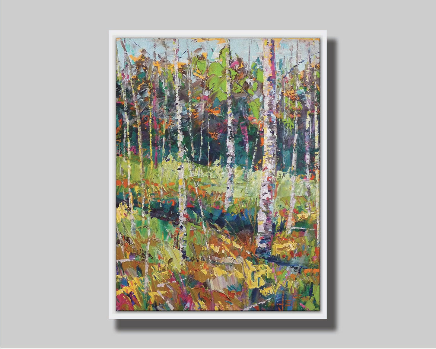 A painting of a birch forest in a variety of colors, from dark blue shadows in the distance to soft green grasses. Printed on canvas in a float frame.