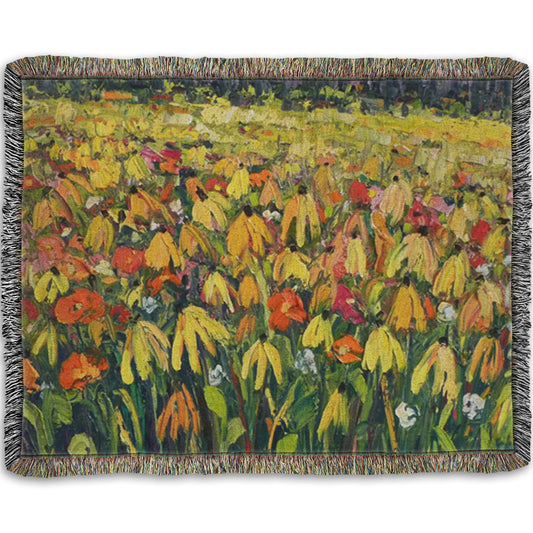 A woven throw blanket designed with a painting of a field of yellow coneflowers, accented by other orange, pink, red, and white wildflowers.