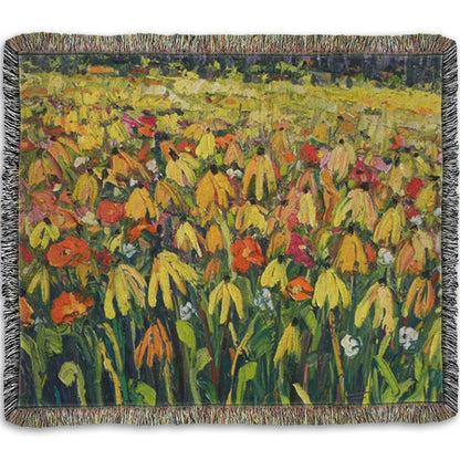A woven throw blanket designed with a painting of a field of yellow coneflowers, accented by other orange, pink, red, and white wildflowers.