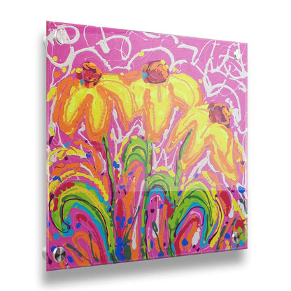 A painting of three yellow wildflowers on a pink background, accented by orange, blue, green, and white. It was created by dripping paint onto the substrate. Printed on acrylic.