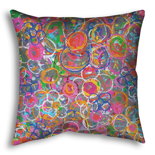 A throw pillow designed with an abstract drip painting of many simplified flower shapes, utilizing a wide range of bright colors.