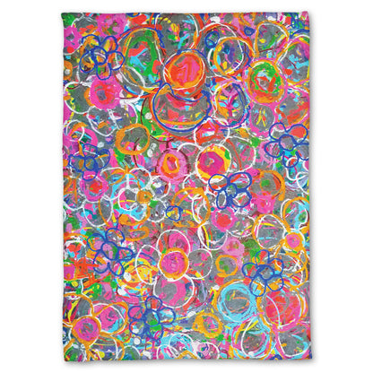 A fleece throw blanket designed with an abstract drip painting of many simplified flower shapes, utilizing a wide range of bright colors.