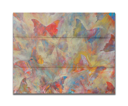 An abstracted painting of a pattern of butterflies, created in an array of colors with textured brushstrokes. Printed on a box board.