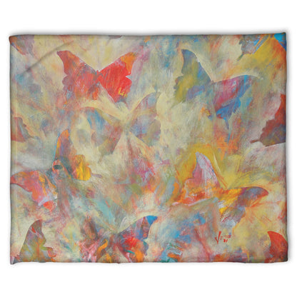 A fleece throw blanket designed with an abstracted painting of a pattern of butterflies, created in an array of colors with textured brushstrokes.