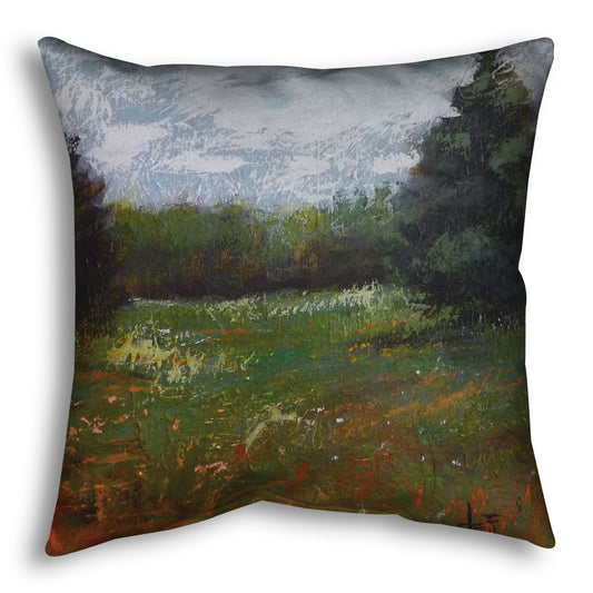 A throw pillow designed with an expressive painting of a grassy field and grove of trees.