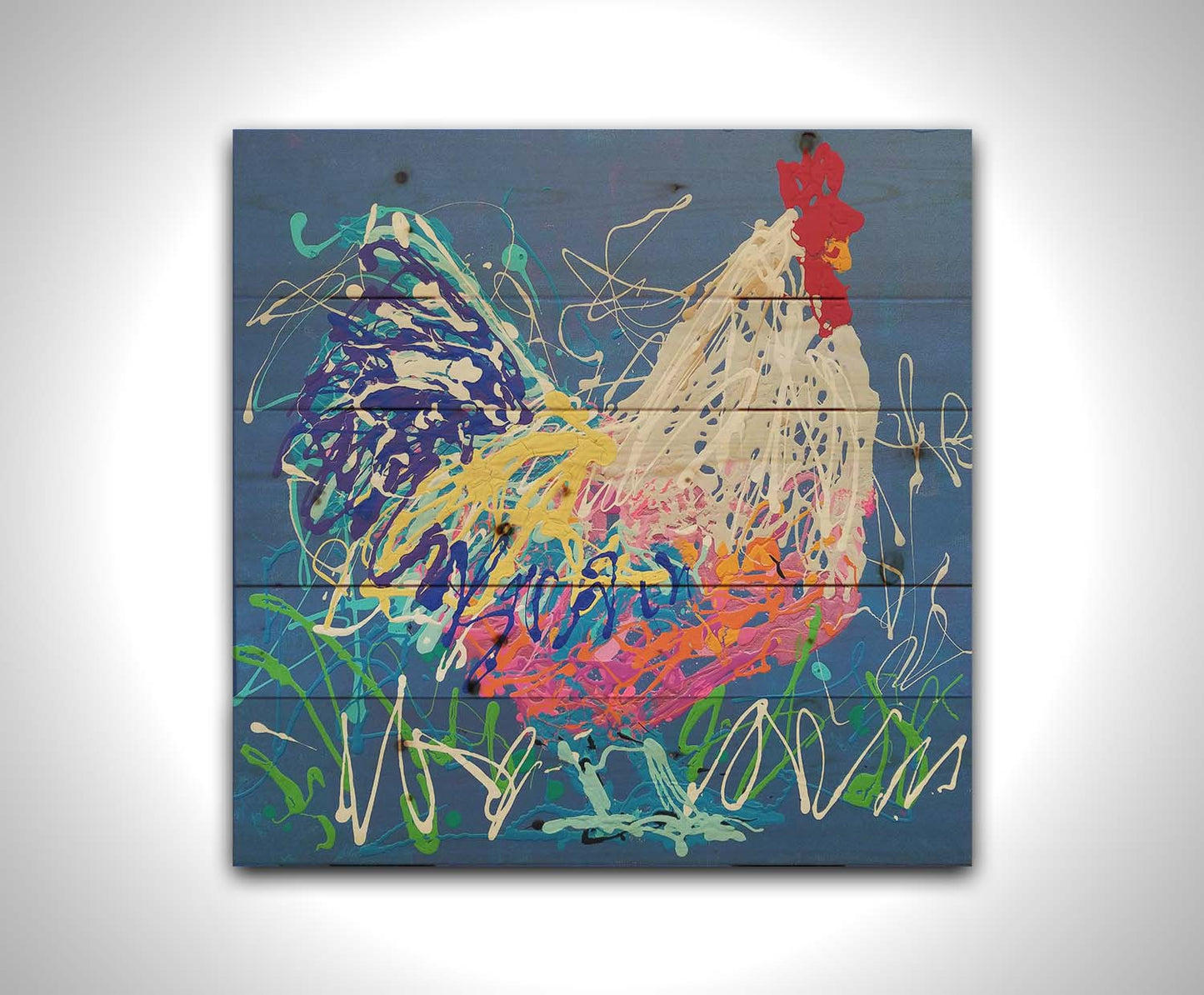 A drip painting of a white and blue rooster on a gentle blue background, splattered with accents of green, white, pink, and yellow. Printed on a wood pallet.