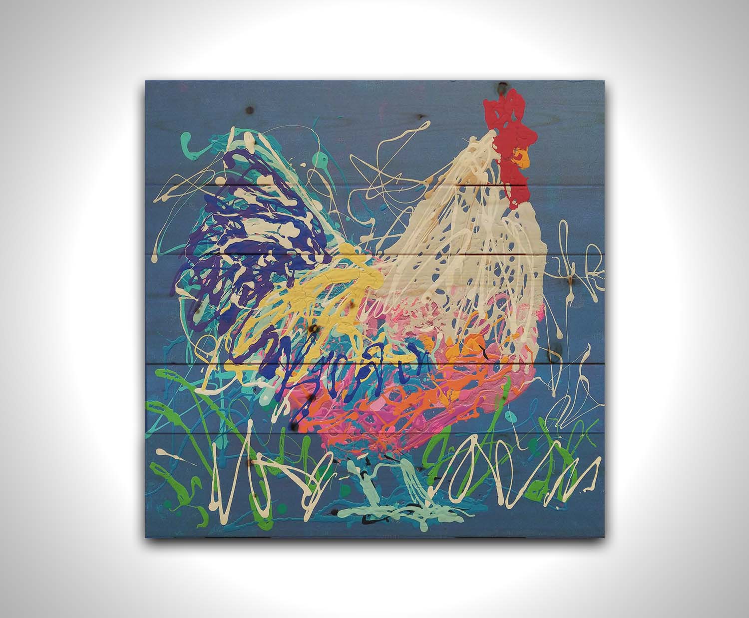 A drip painting of a white and blue rooster on a gentle blue background, splattered with accents of green, white, pink, and yellow. Printed on a wood pallet.