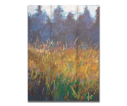 An expressive painting of a gold and green field in front of a purple and blue forest. Printed on a box board.