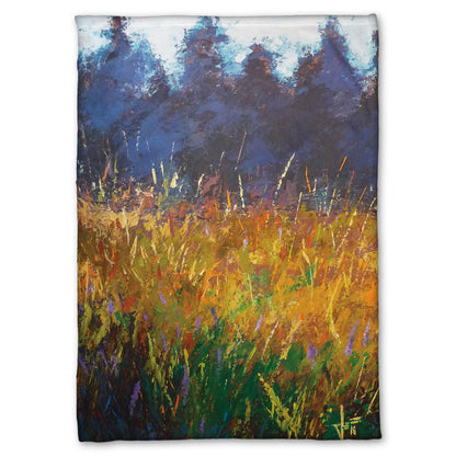 A fleece throw blanket designed with an expressive painting of a gold and green field in front of a purple and blue forest.