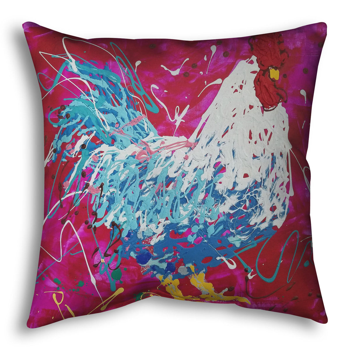 A square throw pillow designed with a drip painting of a white and blue rooster on a red and pink background, accented by white, yellow, green, and brown.