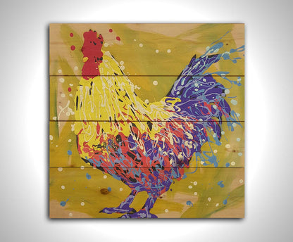 A drip painting of a yellow and blue rooster, accented by red and white, against a yellow-green background. Printed on a wood pallet.