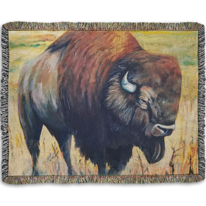 A woven throw blanket designed with a painting of an American bison, standing in a light yellow field.