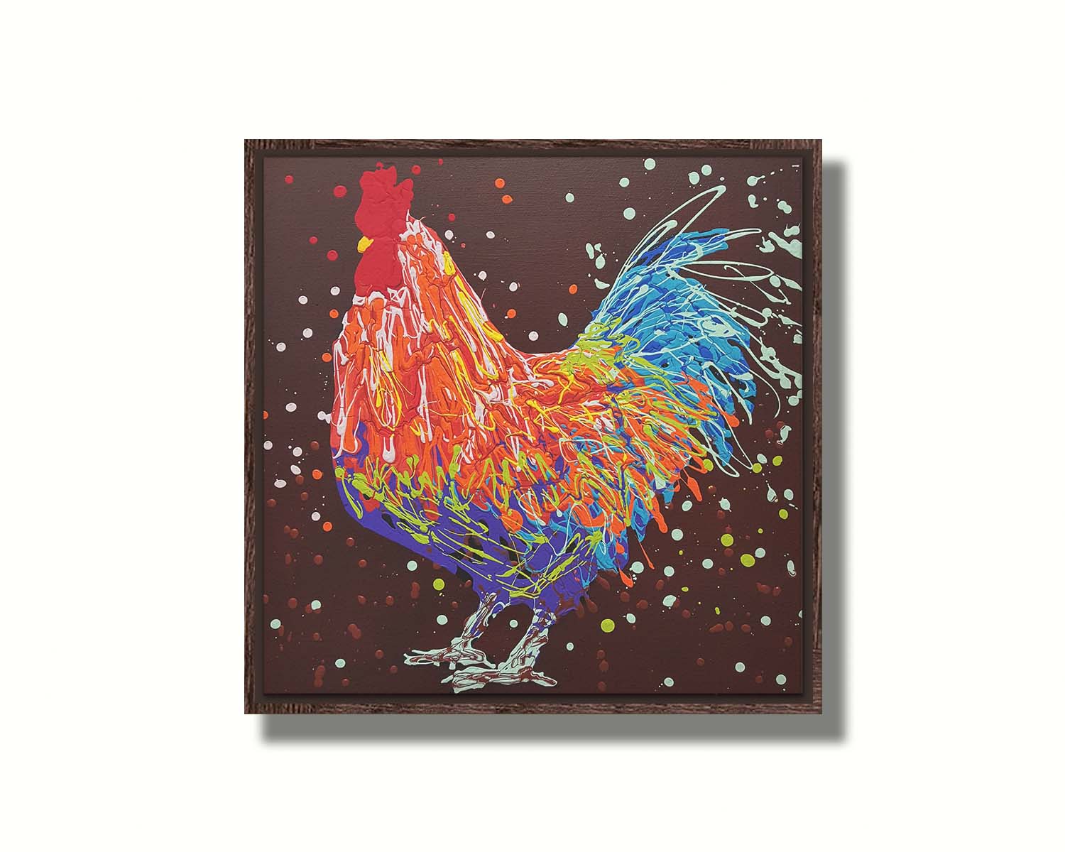 A drip painting of an orange, blue, and red rooster against a brown background. Printed on canvas in a float frame.