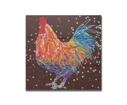 A drip painting of an orange, blue, and red rooster against a brown background. Printed on a box board.