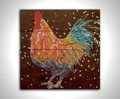 A drip painting of an orange, blue, and red rooster against a brown background. Printed on a wood pallet.