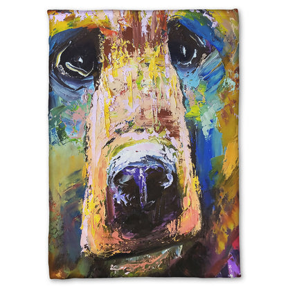 A fleece throw blanket designed with a painting of a bear's face closeup, accented with blue and yellow.