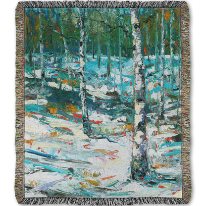 A woven throw blanket designed with an expressive painting of a snowy birch forest.