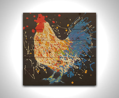 A drip painting of a white and blue rooster on a black background, accented with yellow, red, purple, and green. Printed on a wood pallet.