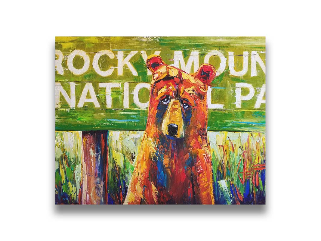 A painting of a bear standing in front of a "Rocky Mountain National Park" sign. Printed on canvas.