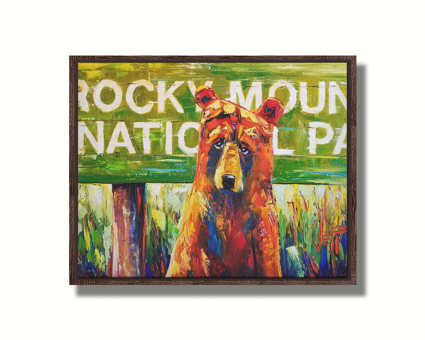 A painting of a bear standing in front of a "Rocky Mountain National Park" sign. Printed on canvas in a float frame.