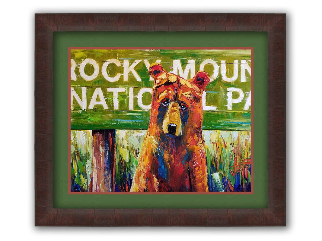 A painting of a bear standing in front of a "Rocky Mountain National Park" sign. Printed on paper, matted, and framed.