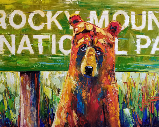 A painting of a bear standing in front of a "Rocky Mountain National Park" sign. 