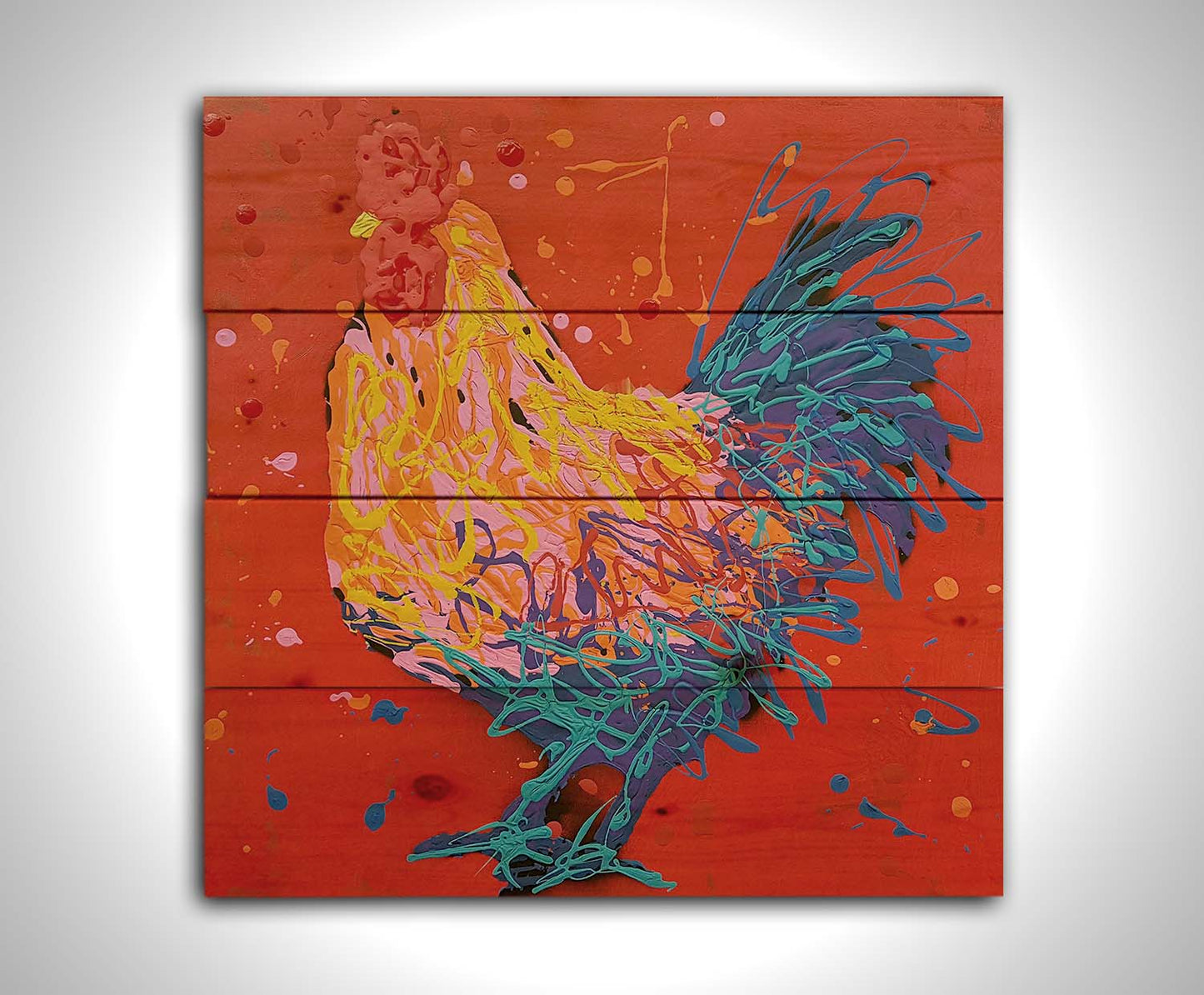 A drip painting of a blue, pink, and yellow rooster on a bright red background. Printed on a wood pallet.