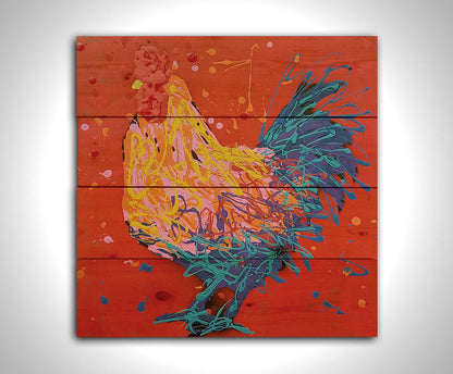 A drip painting of a blue, pink, and yellow rooster on a bright red background. Printed on a wood pallet.