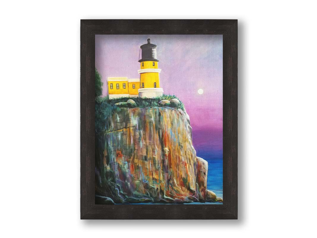 A painting of a bright yellow lighthouse perched on a cliff face above a vibrant blue sea, with a pink and purple sky. Printed on canvas and framed.