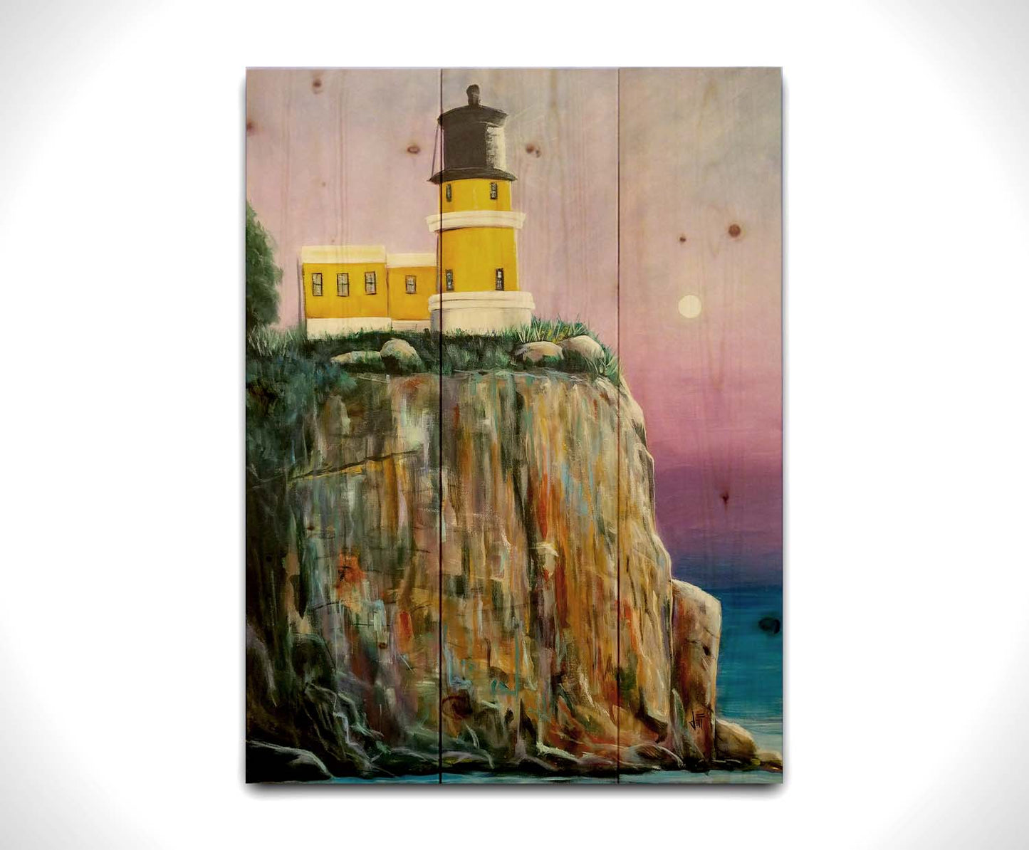 A painting of a bright yellow lighthouse perched on a cliff face above a vibrant blue sea, with a pink and purple sky. Printed on a wood pallet.