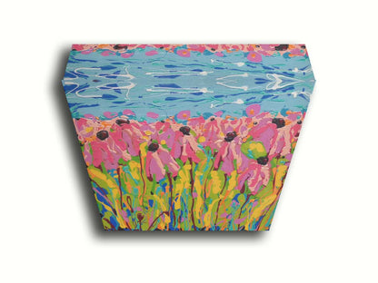 A drip painting of a field of pink wildflowers against a blue background. Printed on canvas.