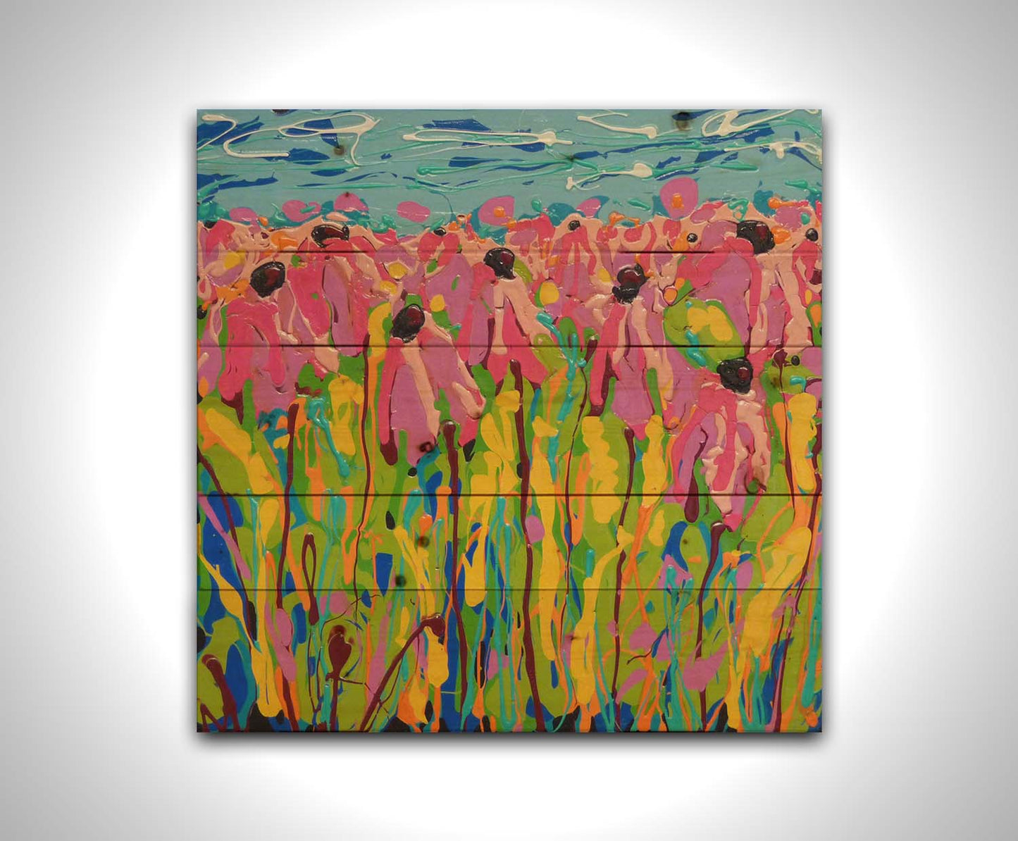 A drip painting of a field of pink wildflowers against a blue background. Printed on a wood pallet.