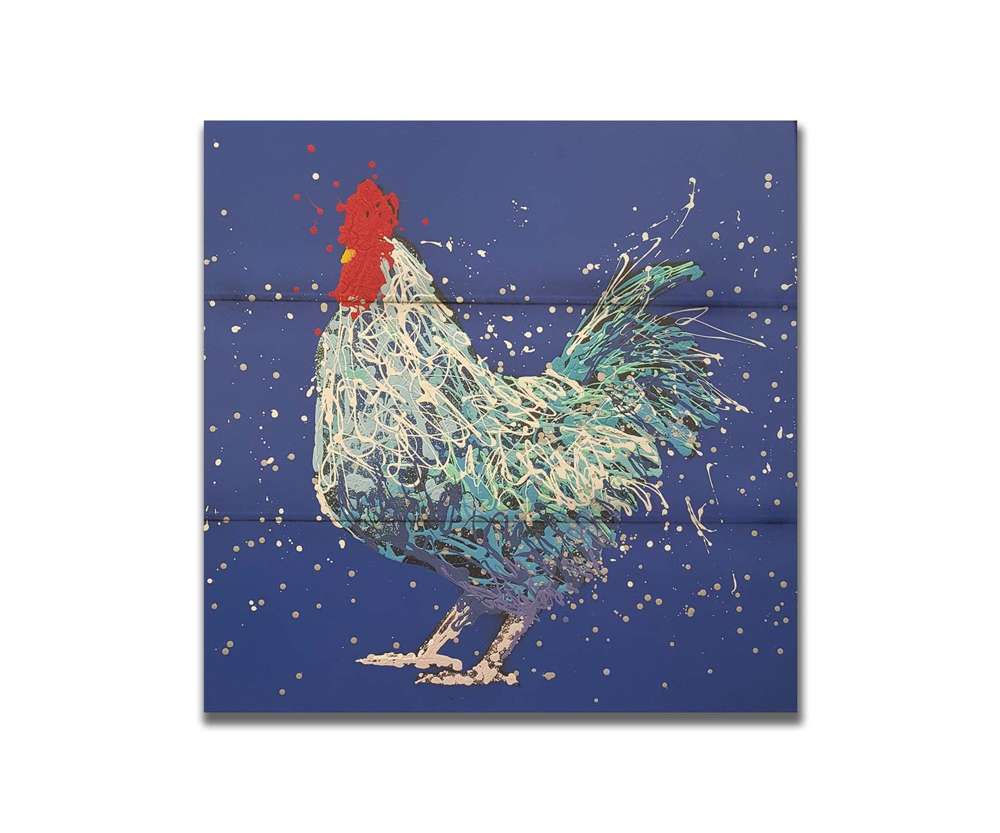 A drip painting of a white and blue rooster on a vibrant blue background. Printed on a box board.