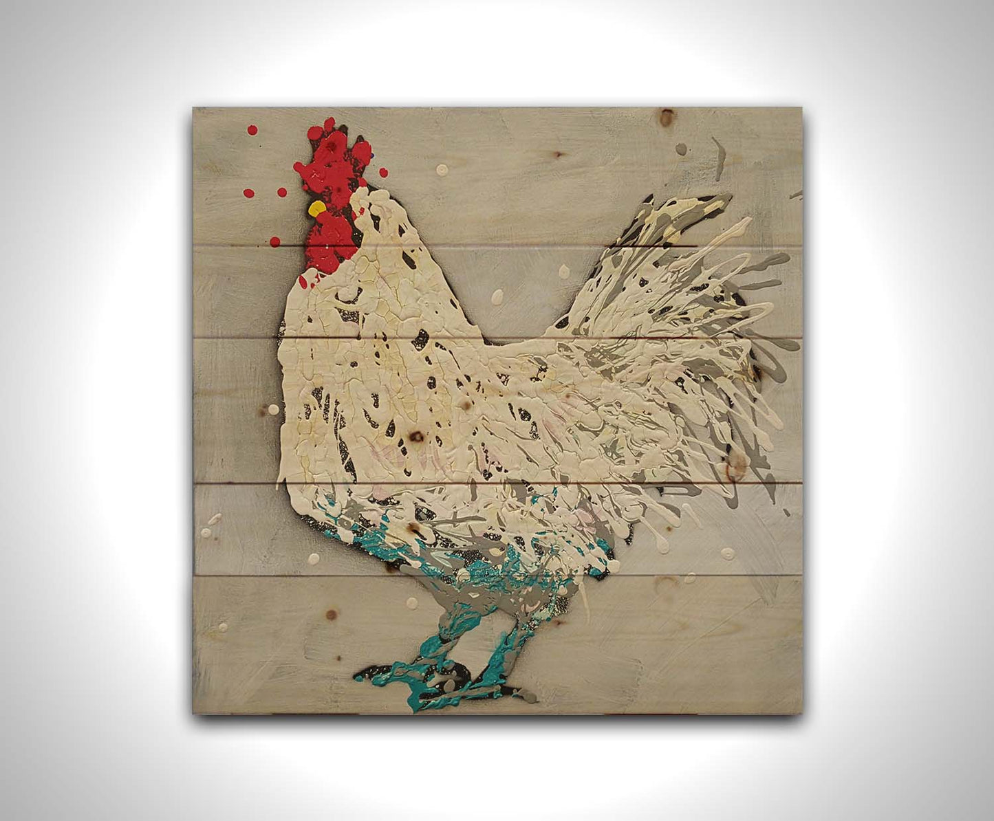 A drip painting of a white rooster on a gray background, accented with red, yellow, and blue. Printed on a wood pallet.