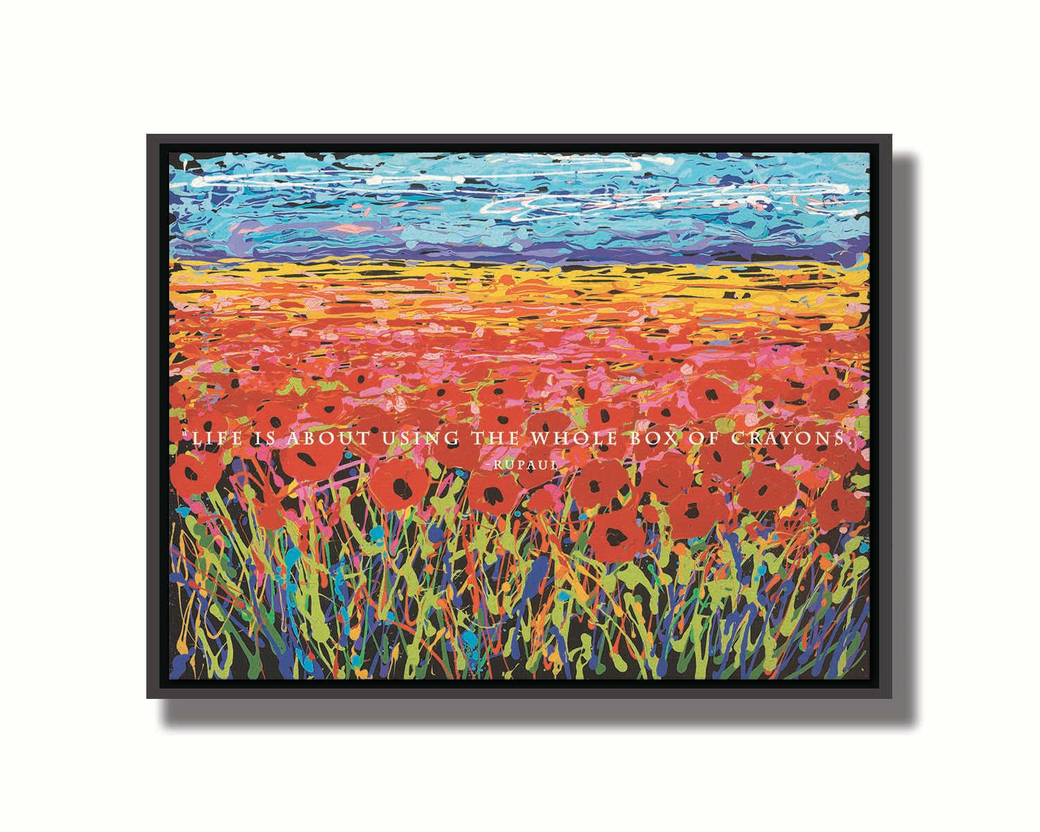 A drip painting of a field of red flowers, created with a rainbow of vibrant colors. White text in the middle reads "Life is about using the whole box of crayons." Printed on canvas in a float frame.